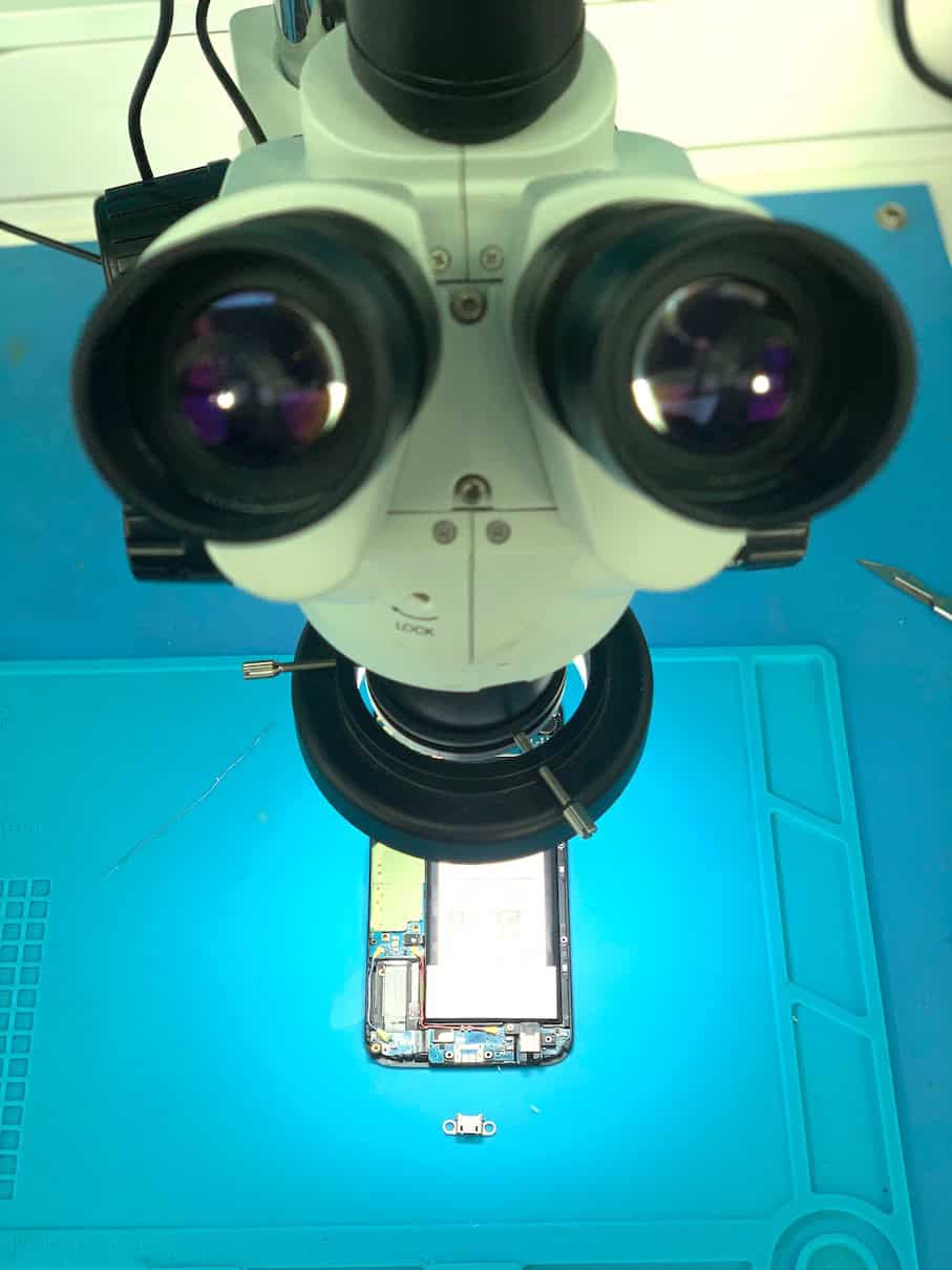 Phone motherboard inspection under microscope at Fixfactor