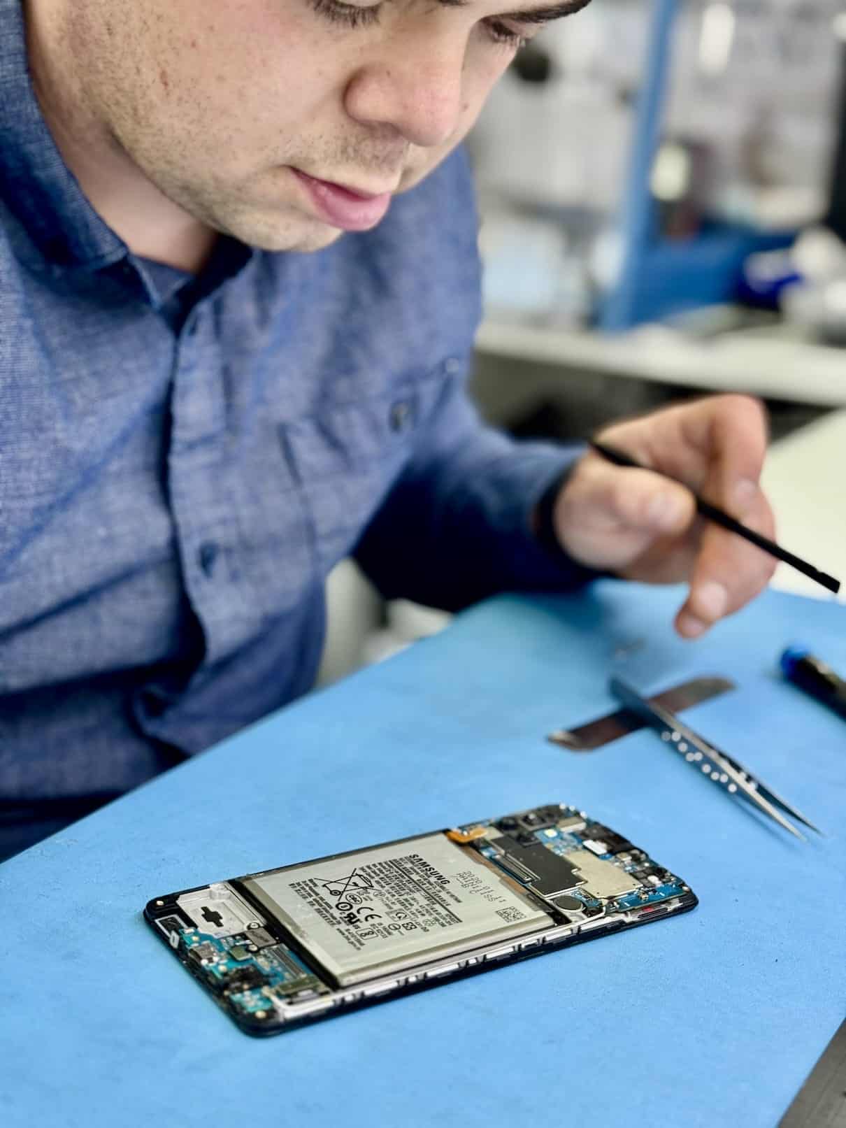 Professional technician handling delicate repair