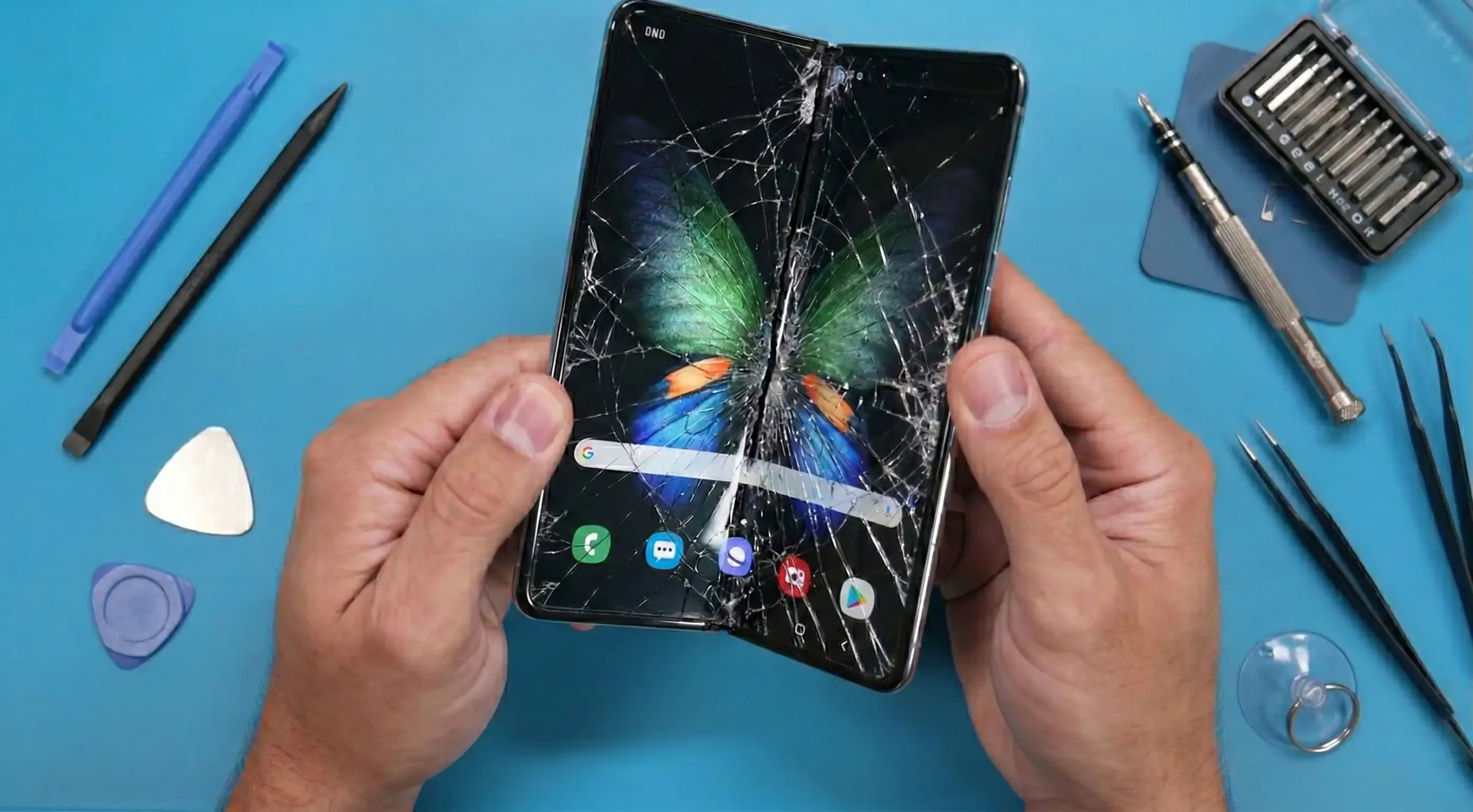 Broken Samsung Galaxy foldable phone screen — cracked flexible OLED display at the fold point